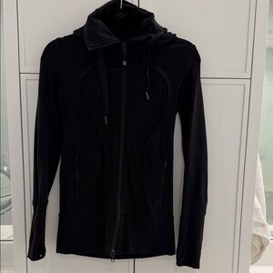 Lululemon long fitted hooded jacket with ruffle logo. Size 4. Very  flattering.